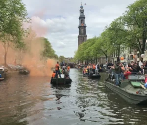Boat on the canal during King's Day in Amsterdam